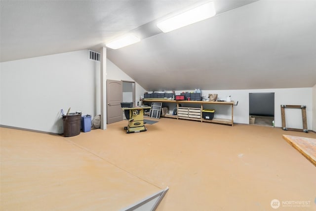 additional living space with visible vents and vaulted ceiling