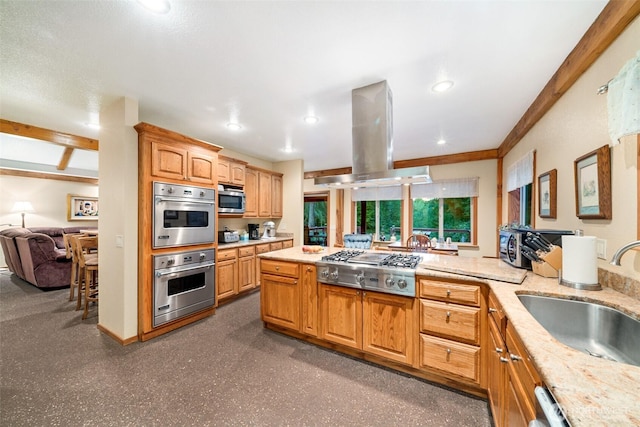 kitchen featuring recessed lighting, a sink, open floor plan, appliances with stainless steel finishes, and island exhaust hood