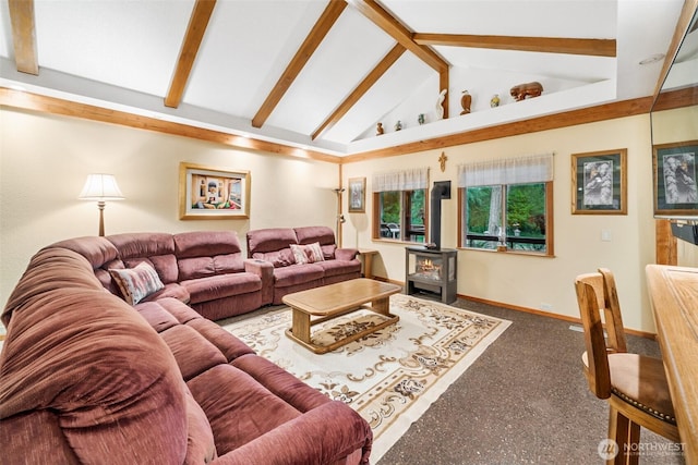 living room with a wood stove, lofted ceiling with beams, and baseboards