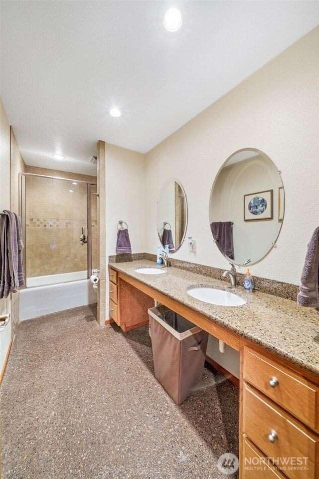 full bath with recessed lighting, shower / bath combination with glass door, a sink, and double vanity