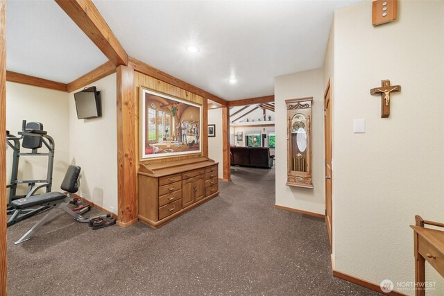 hall with beam ceiling and baseboards