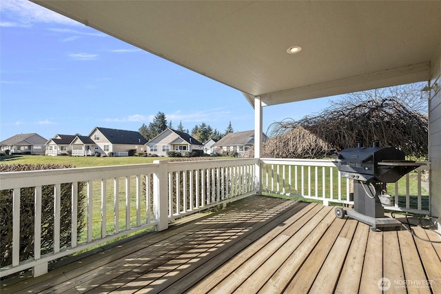 deck featuring a residential view and a grill