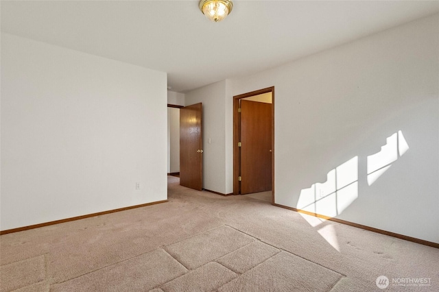 empty room with carpet floors and baseboards