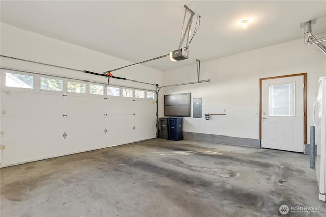 garage with electric panel and a garage door opener