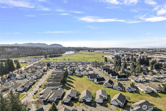 drone / aerial view featuring a residential view and a water and mountain view