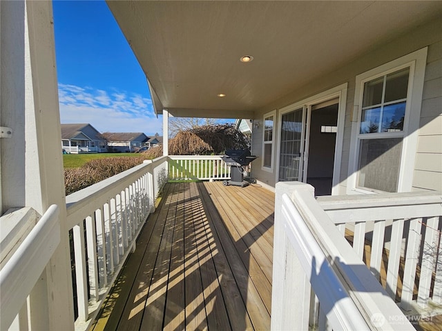 wooden terrace with a residential view and grilling area