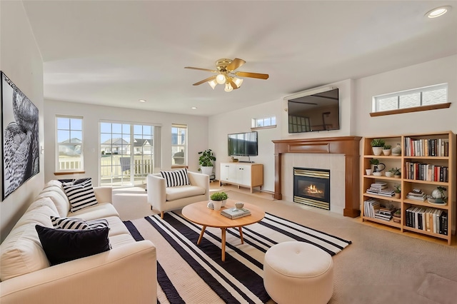 carpeted living area with recessed lighting, ceiling fan, and a tiled fireplace