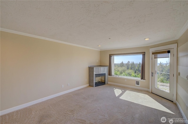 unfurnished living room with a fireplace, light colored carpet, ornamental molding, a textured ceiling, and baseboards