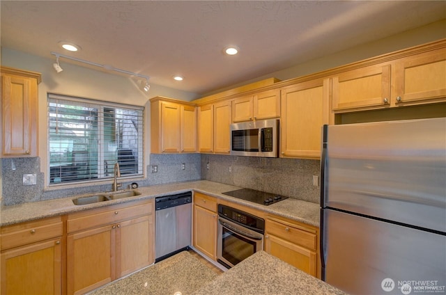 kitchen with light brown cabinets, appliances with stainless steel finishes, backsplash, and a sink