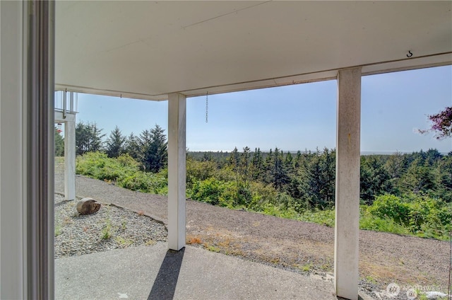 view of patio / terrace with a forest view