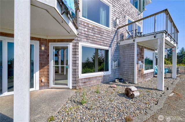 entrance to property featuring a patio area and a balcony