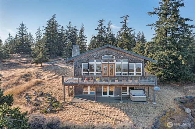 312 Stormridge Rd, Friday Harbor, WA 98250 - back of property with a chimney, a deck, and french doors