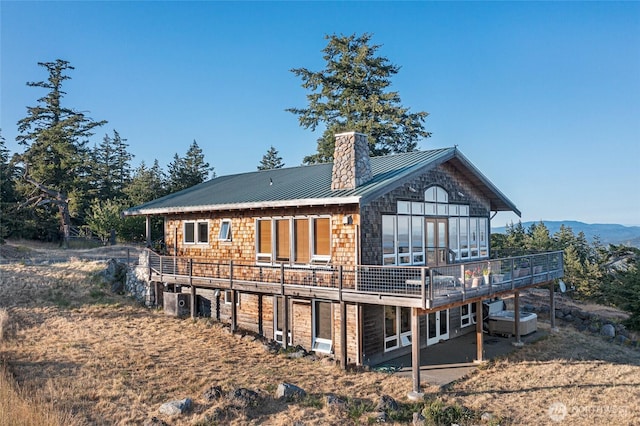 312 Stormridge Rd, Friday Harbor, WA 98250 - rear view of property featuring metal roof, a deck with mountain view, and a chimney