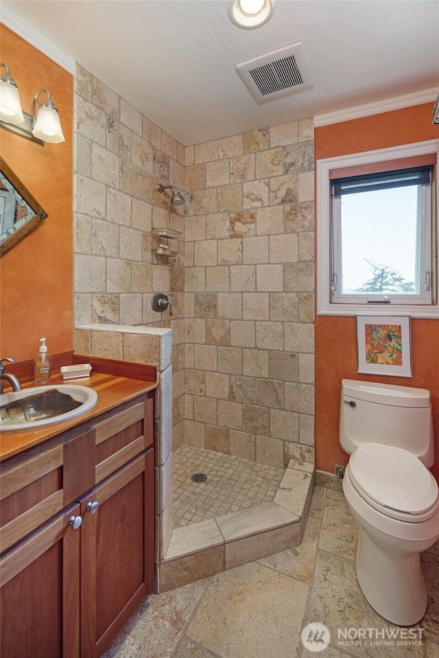 312 Stormridge Rd, Friday Harbor, WA 98250 - full bath with visible vents, toilet, a tile shower, and stone tile flooring