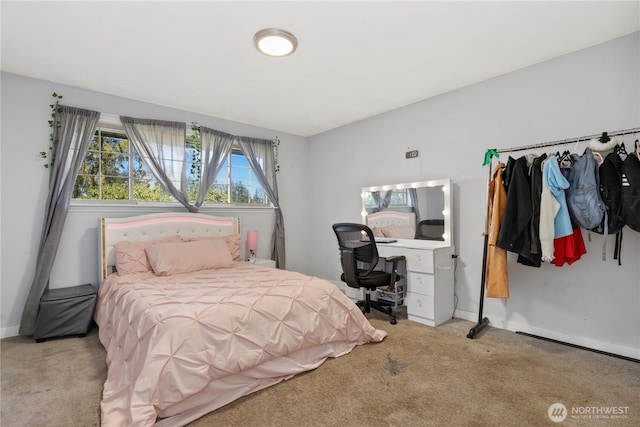 carpeted bedroom featuring baseboards