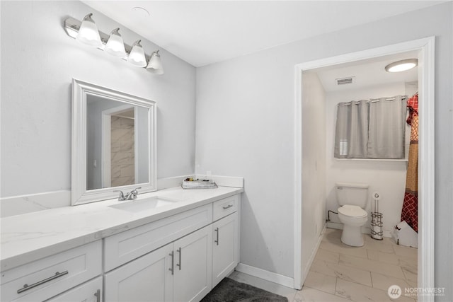 bathroom with baseboards, visible vents, toilet, marble finish floor, and vanity