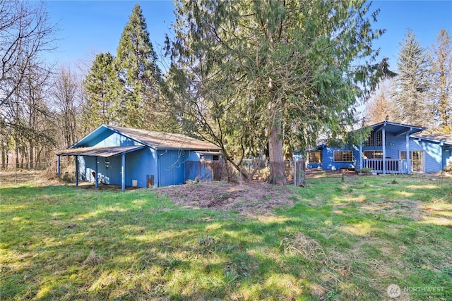 view of yard with an outbuilding and fence