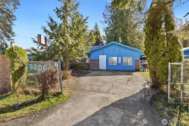 view of front of home featuring fence and driveway