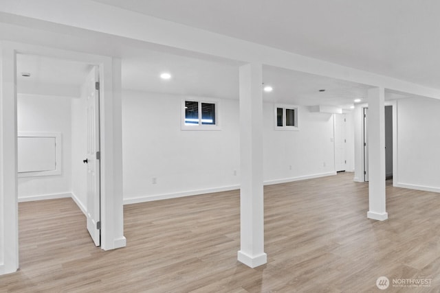 finished basement featuring baseboards, recessed lighting, and light wood-style floors