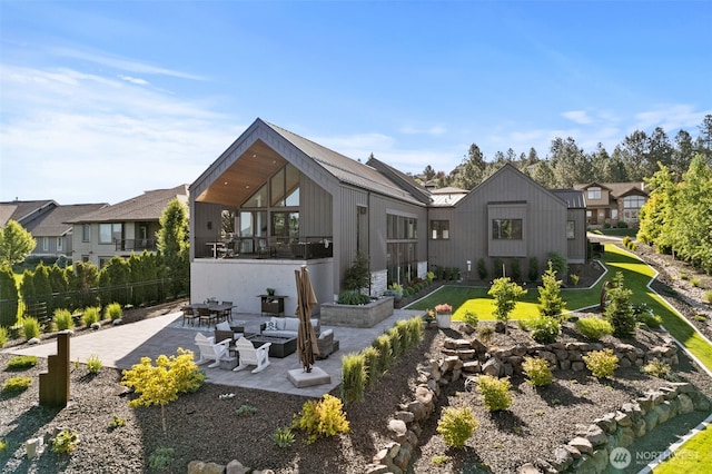 rear view of house with a patio area, fence, and a lawn