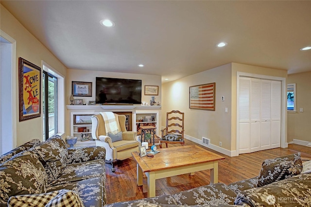 living room featuring wood finished floors, visible vents, and recessed lighting