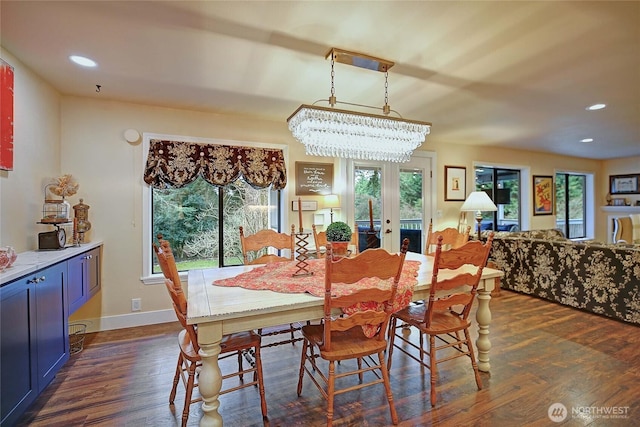 dining space with dark wood-style floors, baseboards, and a healthy amount of sunlight