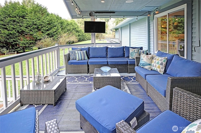 wooden deck with an outdoor living space