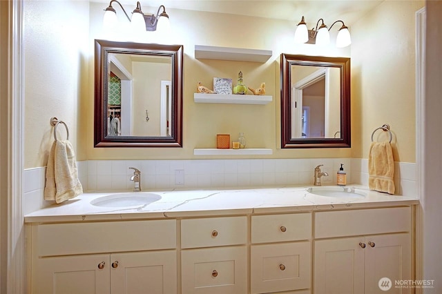 bathroom with a sink and double vanity