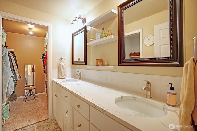 bathroom featuring double vanity, decorative backsplash, and a sink