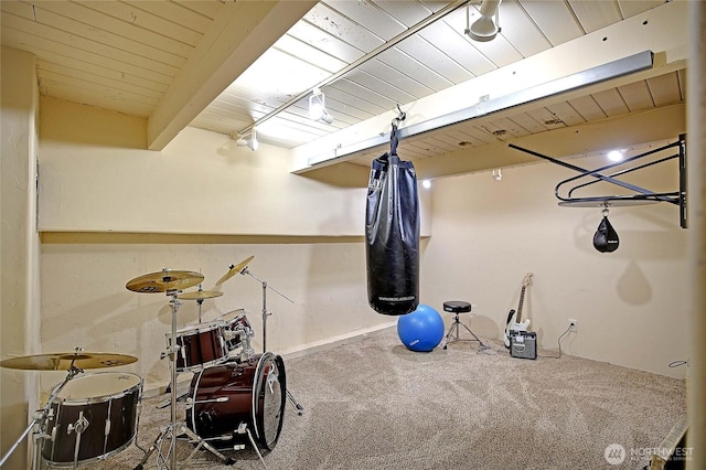 rec room with beam ceiling, wooden ceiling, and carpet flooring