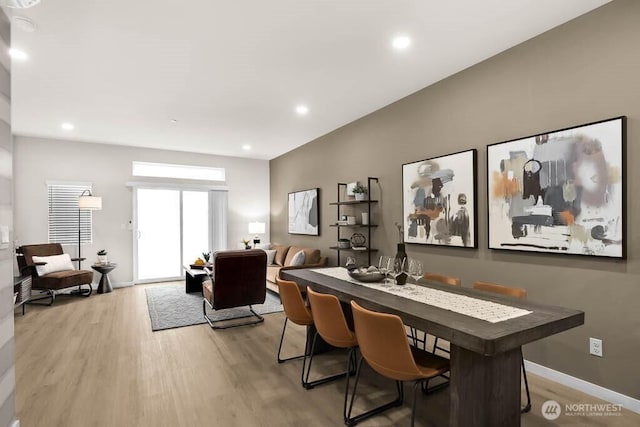 dining space featuring light wood-style flooring, baseboards, and recessed lighting