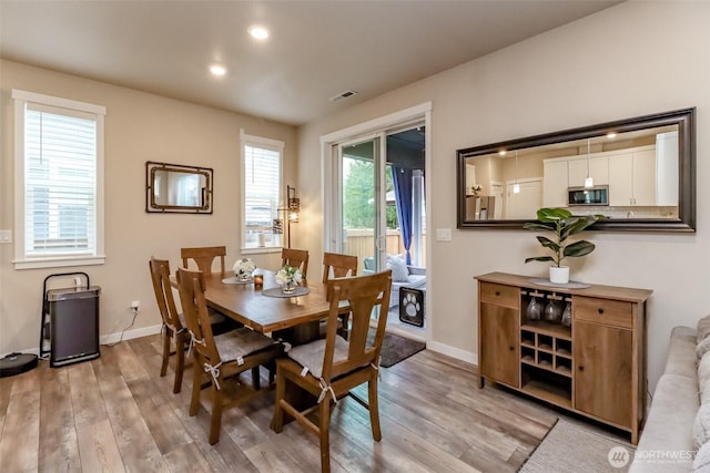 dining room featuring baseboards, recessed lighting, visible vents, and light wood-style floors