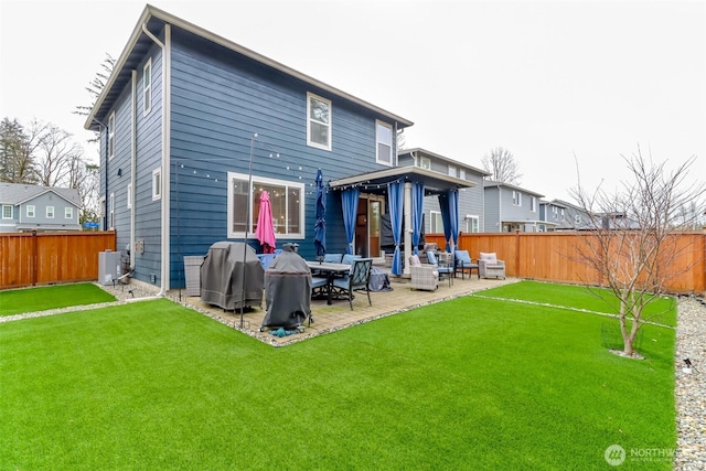 rear view of property with a fenced backyard, a lawn, central AC, and a patio