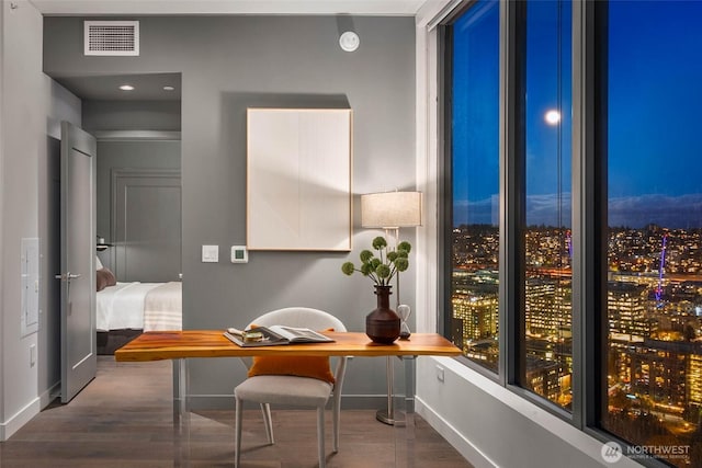 office featuring visible vents, baseboards, and wood finished floors