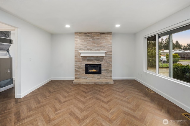 unfurnished living room featuring recessed lighting, visible vents, a fireplace, and baseboards