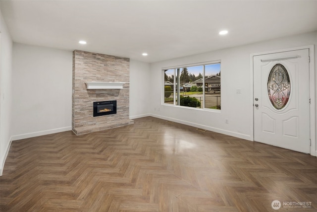 unfurnished living room with visible vents, a fireplace, baseboards, and recessed lighting