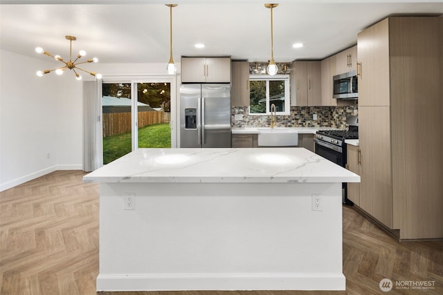 kitchen with a center island, decorative light fixtures, stainless steel appliances, decorative backsplash, and a sink