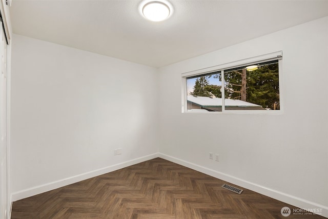 empty room with visible vents and baseboards