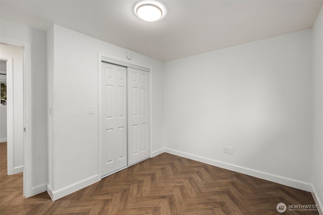 unfurnished bedroom featuring a closet and baseboards