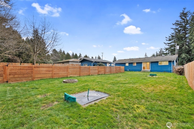 view of yard with an outdoor fire pit and a fenced backyard