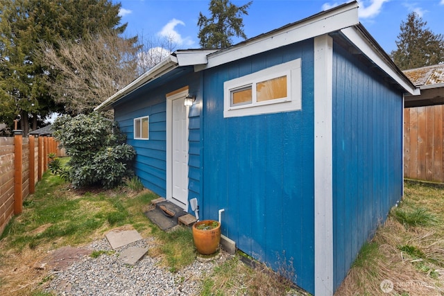 view of outdoor structure featuring an outbuilding and a fenced backyard