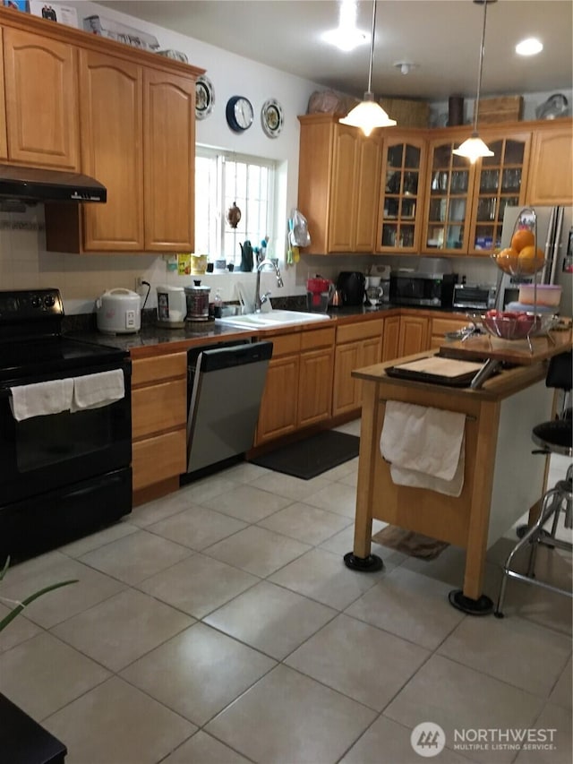 kitchen featuring light tile patterned floors, dishwasher, under cabinet range hood, black range with electric cooktop, and a sink