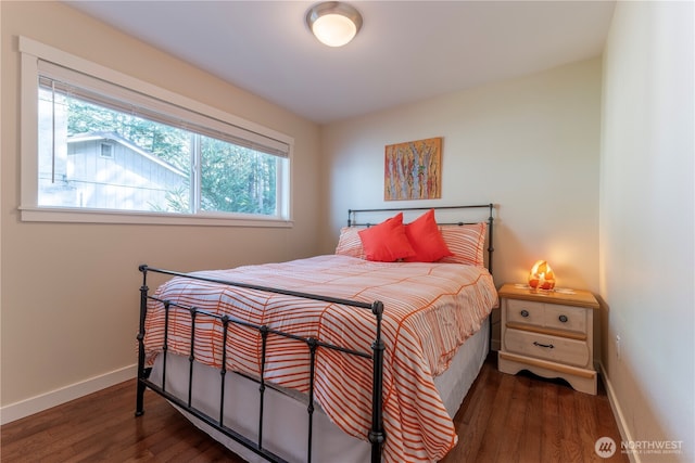 bedroom with baseboards and wood finished floors