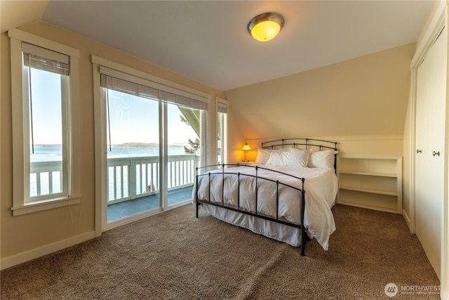 carpeted bedroom featuring baseboards and access to exterior