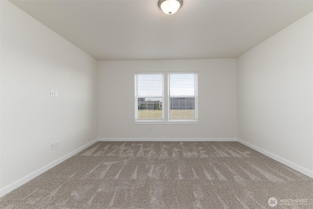 carpeted empty room with baseboards