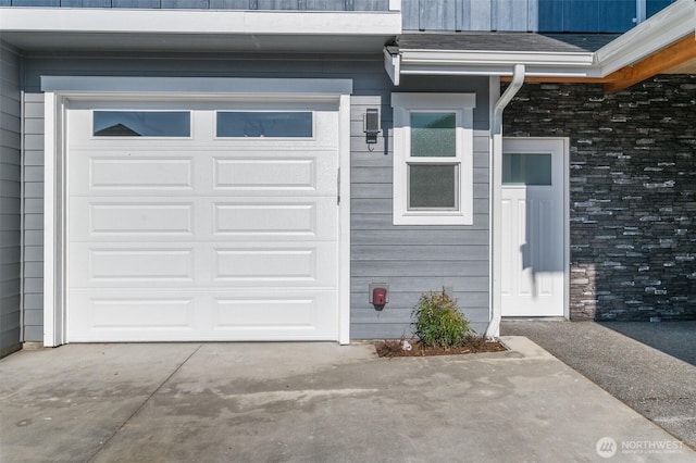 garage featuring concrete driveway