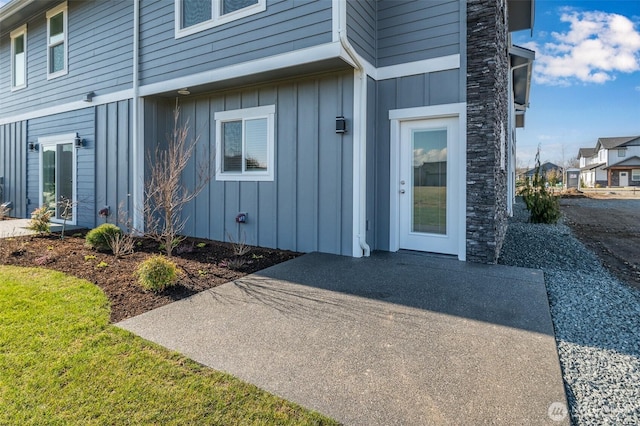 entrance to property with a patio area and board and batten siding