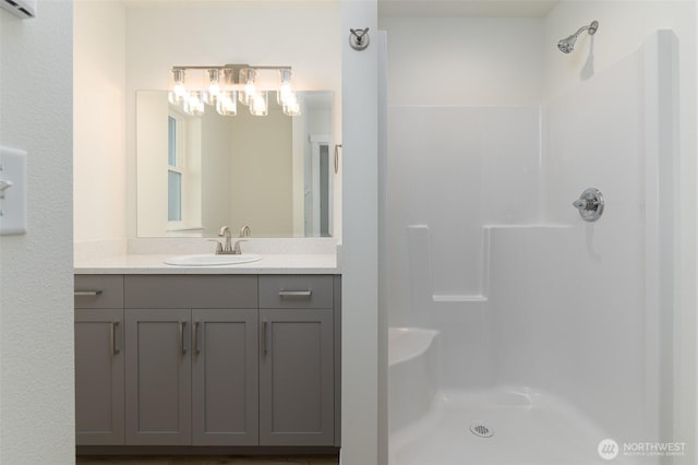 full bath featuring walk in shower and vanity