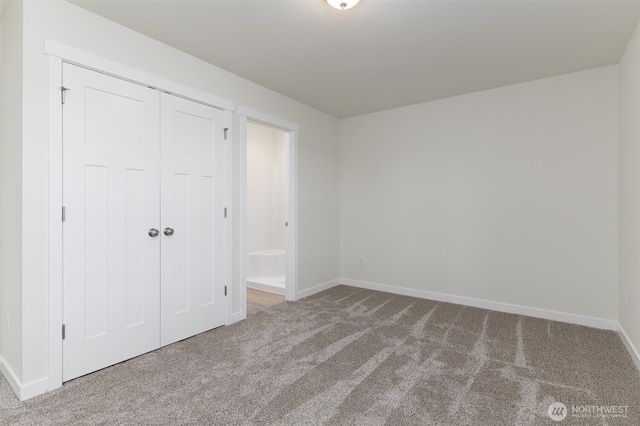 unfurnished bedroom featuring a closet, carpet, and baseboards