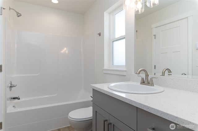 full bathroom featuring toilet, shower / bathing tub combination, and vanity